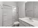 Bathroom with a walk-in shower, white cabinets, and quartz countertop and sink at 54 Grove Township Way, Angier, NC 27501