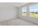 Bedroom featuring two large windows overlooking a sunny, green landscape at 54 Grove Township Way, Angier, NC 27501