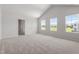 Bright bedroom with three windows and neutral carpet, with en suite access at 54 Grove Township Way, Angier, NC 27501