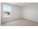 Bright, empty bedroom with neutral carpet, large window and view to new construction at 54 Grove Township Way, Angier, NC 27501