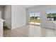 Open dining room leading to deck and large windows for a light filled space with beautiful flooring at 54 Grove Township Way, Angier, NC 27501