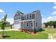 Stately home with gray siding, white trim, and lush green lawn in a quiet neighborhood at 54 Grove Township Way, Angier, NC 27501