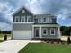 Charming two-story home with a two-car garage and a well-manicured lawn at 54 Grove Township Way, Angier, NC 27501