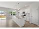Modern kitchen with white cabinets, granite countertops, stainless steel appliances, and a center island at 54 Grove Township Way, Angier, NC 27501