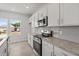 Bright kitchen featuring white cabinets, stainless steel appliances, and granite counters for a modern look at 54 Grove Township Way, Angier, NC 27501