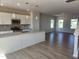 Bright, modern kitchen with stainless steel appliances, granite counters, and hardwood floors at 54 Grove Township Way, Angier, NC 27501