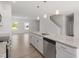 Open kitchen featuring granite counters, stainless steel appliances, white cabinets and large island with pendant lighting at 54 Grove Township Way, Angier, NC 27501