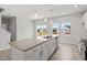 Bright kitchen with granite counters, white cabinets, stainless steel appliances, and a large island with pendant lighting at 54 Grove Township Way, Angier, NC 27501