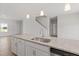 Island in the kitchen featuring granite counters, stainless steel appliances, white cabinets and pendant lighting at 54 Grove Township Way, Angier, NC 27501