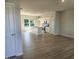 Open-concept kitchen and living area with modern white cabinets and stainless steel appliances at 54 Grove Township Way, Angier, NC 27501