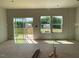 Sun-filled living area with sliding doors and windows that offer backyard views at 54 Grove Township Way, Angier, NC 27501