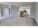 Bright living room with an open floor plan, leading to a modern kitchen area at 54 Grove Township Way, Angier, NC 27501
