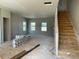 Open living area with stairs, large windows, and unfinished walls for a personalized touch at 54 Grove Township Way, Angier, NC 27501