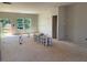 Spacious living area with unfinished walls, large windows, and access to the backyard at 54 Grove Township Way, Angier, NC 27501