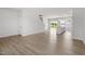 Open-concept living area with sleek flooring, white walls, and easy access to the kitchen and backyard at 54 Grove Township Way, Angier, NC 27501