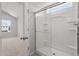Bathroom shower featuring a glass door, bright interior, and convenient built-in shelves at 54 Grove Township Way, Angier, NC 27501