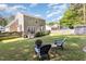 Backyard featuring a fire pit, seating area, and manicured lawn at 5413 Botany Bay Dr, Raleigh, NC 27616
