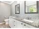 Bathroom features a double sink vanity with granite countertop and white cabinets at 5413 Botany Bay Dr, Raleigh, NC 27616