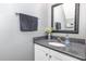Stylish bathroom with a granite countertop and decorative mirror at 5413 Botany Bay Dr, Raleigh, NC 27616