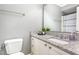 Updated bathroom with granite countertop, white cabinets, and modern fixtures at 5413 Botany Bay Dr, Raleigh, NC 27616
