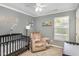 Charming Bedroom with crib, chair, and natural light from the window at 5413 Botany Bay Dr, Raleigh, NC 27616
