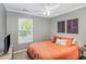 Cozy bedroom with a ceiling fan and window for natural light at 5413 Botany Bay Dr, Raleigh, NC 27616