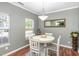 Bright dining area featuring a white round table, modern light fixture, and ample natural light at 5413 Botany Bay Dr, Raleigh, NC 27616