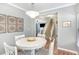 Dining area with a round table with stairs and a living room visible, showcasing an open floor plan at 5413 Botany Bay Dr, Raleigh, NC 27616