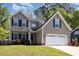 Charming two-story home featuring a two-car garage, manicured lawn, and traditional vinyl siding at 5413 Botany Bay Dr, Raleigh, NC 27616