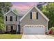 Charming two-story home with a two-car garage, mature trees, and manicured lawn at 5413 Botany Bay Dr, Raleigh, NC 27616