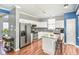 Bright kitchen with white cabinets, a center island with seating, and stainless steel appliances at 5413 Botany Bay Dr, Raleigh, NC 27616
