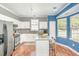 Modern kitchen with white cabinets, granite countertops, stainless steel appliances, and a kitchen island at 5413 Botany Bay Dr, Raleigh, NC 27616