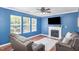 Cozy living room featuring a fireplace, large windows, and comfortable seating at 5413 Botany Bay Dr, Raleigh, NC 27616