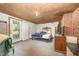 Basement bedroom with exterior door, brick wall, and wood paneled ceiling at 545 Billy Fitts Rd, Siler City, NC 27344