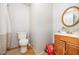 Bathroom features a toilet, sink and a vintage mirror, with a shower curtain to the left at 545 Billy Fitts Rd, Siler City, NC 27344