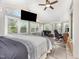 Sunroom with a large bed, wood floors, and multiple windows at 545 Billy Fitts Rd, Siler City, NC 27344