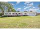 Charming home with a metal roof, white siding, attached garage, and green lawn at 545 Billy Fitts Rd, Siler City, NC 27344