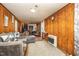 Living room with wood paneled walls, and carpeted flooring, with a heater at 545 Billy Fitts Rd, Siler City, NC 27344