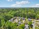 An aerial view of the beautiful homes in this community surrounded by lush green trees and blue skies at 5708 Butter Churn Way, Fuquay Varina, NC 27526