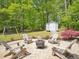 Backyard with a stamped concrete patio featuring a fire pit and Adirondack chairs at 5708 Butter Churn Way, Fuquay Varina, NC 27526