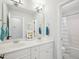 Bright bathroom featuring a double vanity and large mirror and shower with tub at 5708 Butter Churn Way, Fuquay Varina, NC 27526