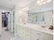 Bright bathroom with double sinks, white cabinets, and a glass-enclosed shower at 5708 Butter Churn Way, Fuquay Varina, NC 27526