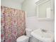 Classic bathroom with sink, toilet, beadboard and floral print shower curtain at 5708 Butter Churn Way, Fuquay Varina, NC 27526