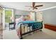 Bedroom featuring a bed with wrought iron frame, dresser, carpeted flooring, and natural light at 5708 Butter Churn Way, Fuquay Varina, NC 27526