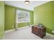Bright room with neutral carpet and walls, a trunk, and a window with bright, natural light at 5708 Butter Churn Way, Fuquay Varina, NC 27526