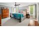 Comfortable bedroom with light gray walls, large windows, and cozy furnishings at 5708 Butter Churn Way, Fuquay Varina, NC 27526