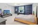 Spacious bedroom with blue accent wall, TV, and light wood bed frame at 5708 Butter Churn Way, Fuquay Varina, NC 27526
