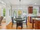 Bright dining area features a glass table, decorative lighting fixture and access to outdoor living at 5708 Butter Churn Way, Fuquay Varina, NC 27526