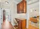Cozy hallway with wooden floors, cabinet desk space, and views of the living room at 5708 Butter Churn Way, Fuquay Varina, NC 27526