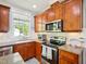 Bright kitchen features a microwave and modern appliances, complemented by white subway tiles at 5708 Butter Churn Way, Fuquay Varina, NC 27526